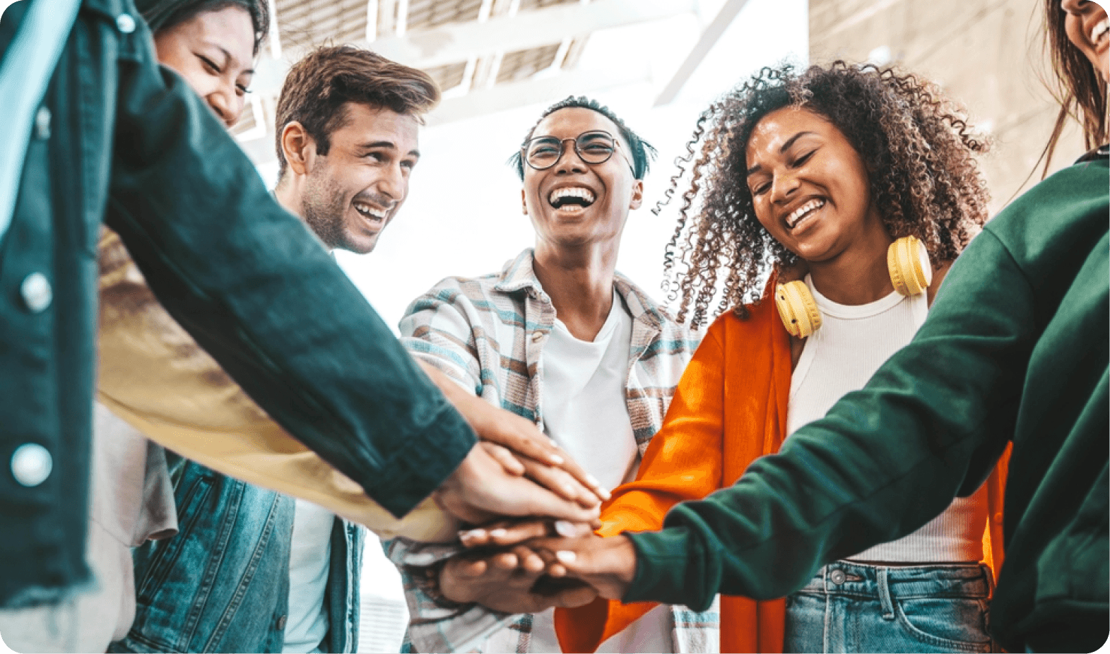 Team members putting hands together in unity